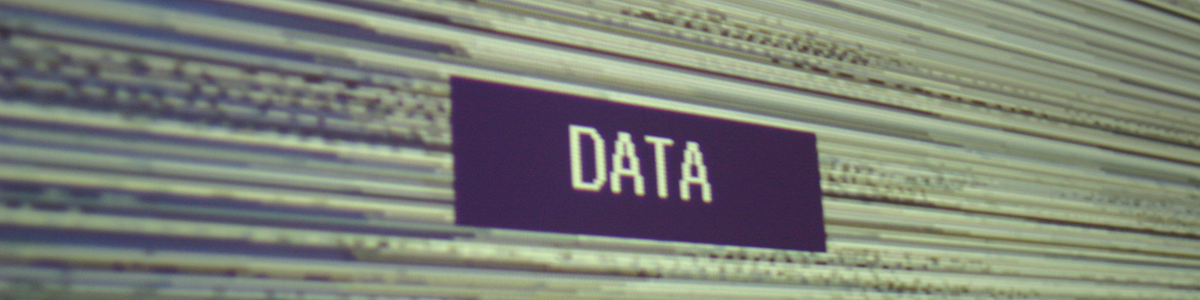 A grainy, grey-scale image depicts the word 'data'.