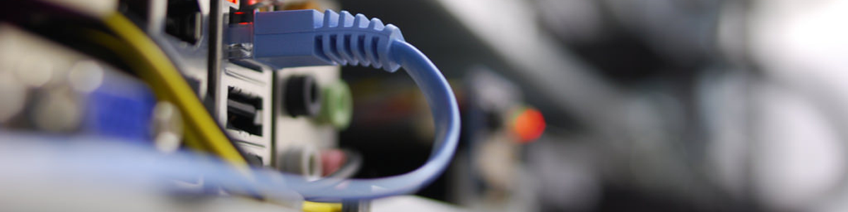 A blue ethernet cable is connected to the rear port of a computer, enabling information to flow to and from the tool.